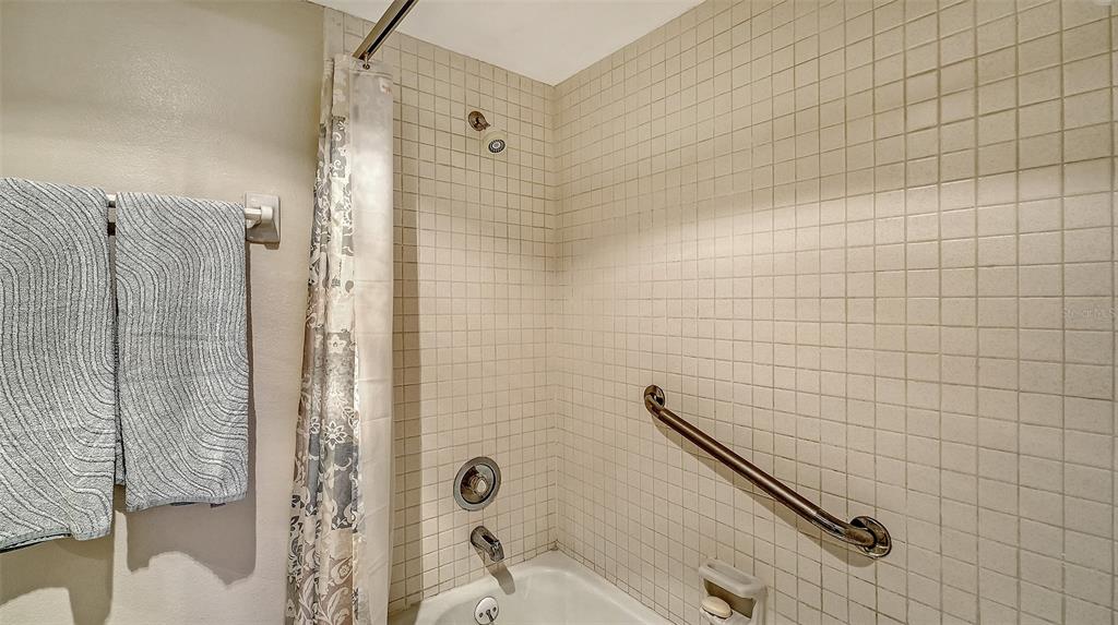 8773 Midnight Pass Road, Unit 102G Sarasota, FL 34242 - Photo 28 of 79 a bathroom with a shower and a toilet