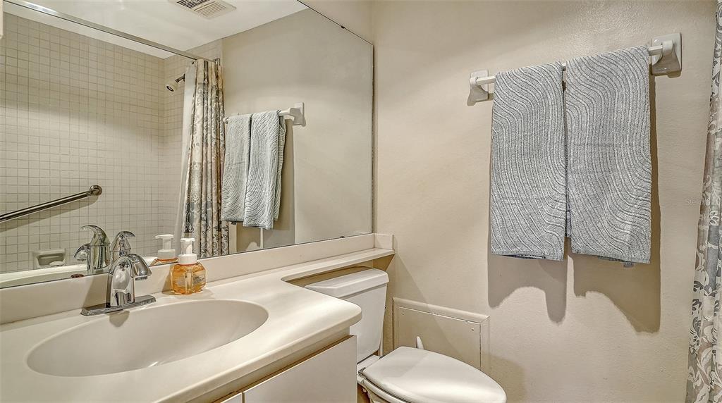 8773 Midnight Pass Road, Unit 102G Sarasota, FL 34242 - Photo 29 of 79 a bathroom with a sink toilet and shower