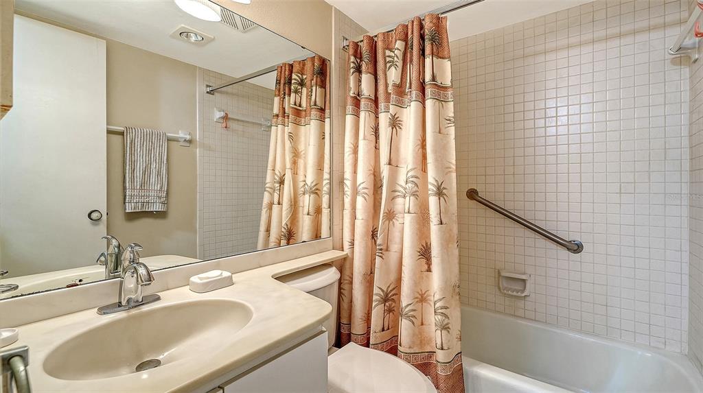 8773 Midnight Pass Road, Unit 102G Sarasota, FL 34242 - Photo 33 of 79 a bathroom with a sink toilet and shower