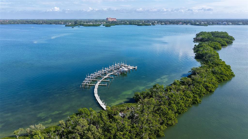 8773 Midnight Pass Road, Unit 102G Sarasota, FL 34242 - Photo 38 of 79 a view of a lake with a mountain in the background