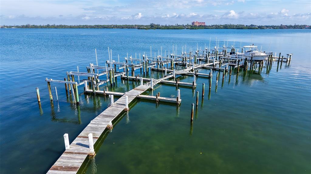 8773 Midnight Pass Road, Unit 102G Sarasota, FL 34242 - Photo 39 of 79 a view of a chairs and table on the terrace