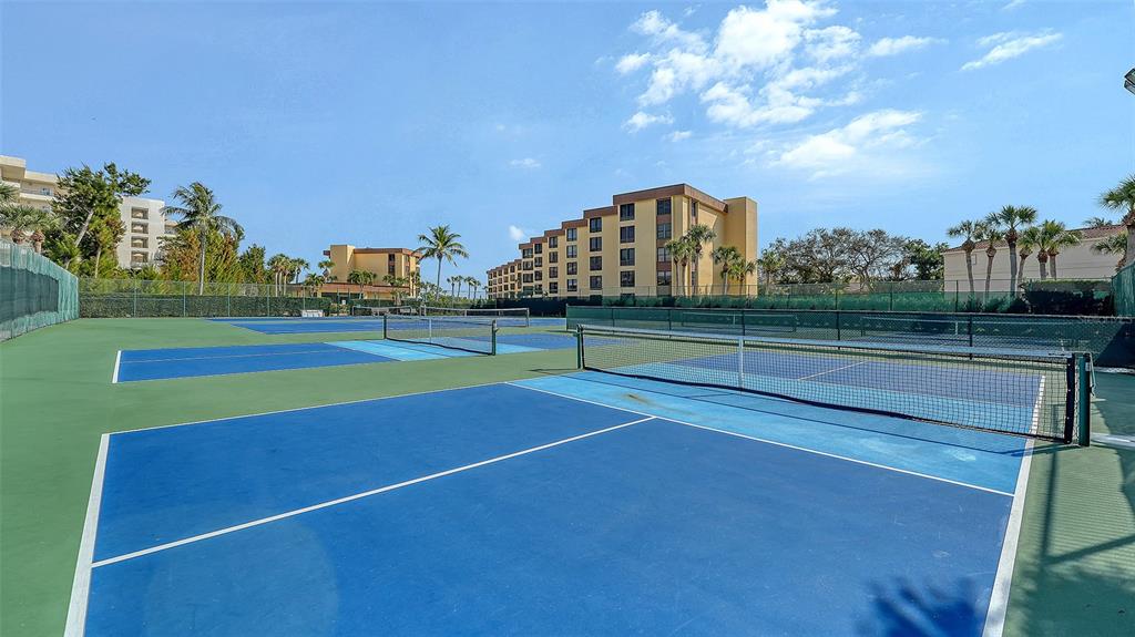8773 Midnight Pass Road, Unit 102G Sarasota, FL 34242 - Photo 54 of 79 a view of an outdoor space and tennis court