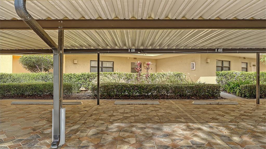 8773 Midnight Pass Road, Unit 102G Sarasota, FL 34242 - Photo 6 of 79 a view of a brick house with a backyard