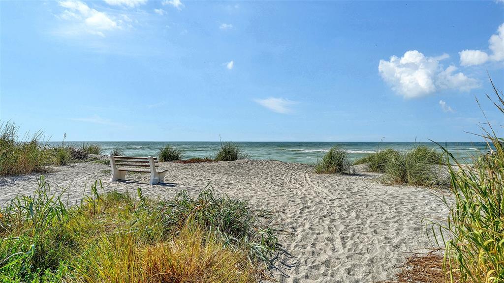 8773 Midnight Pass Road, Unit 102G Sarasota, FL 34242 - Photo 61 of 79 a view of a dry yard with trees in the background