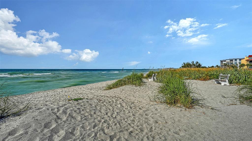 8773 Midnight Pass Road, Unit 102G Sarasota, FL 34242 - Photo 62 of 79 a view of a lake with a beach