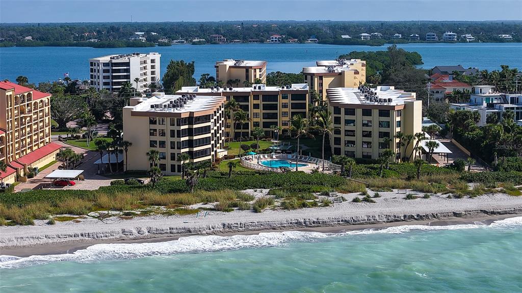 8773 Midnight Pass Road, Unit 102G Sarasota, FL 34242 - Photo 64 of 79 an aerial view of a house with a yard and lake view in back