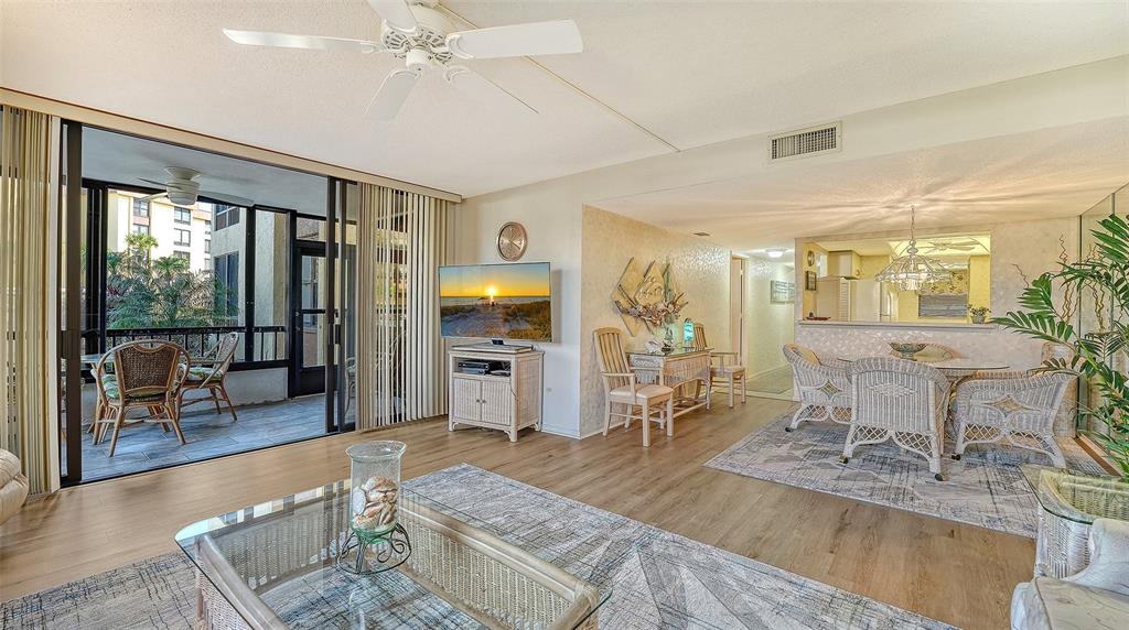 8773 Midnight Pass Road, Unit 102G Sarasota, FL 34242 - Photo 10 of 79 a living room with furniture and large windows