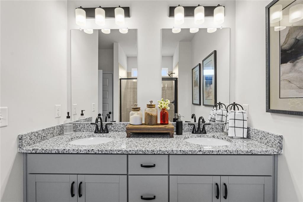 237 Bastian Drive, Unit 18 Villa Rica, GA 30180 - Photo 30 of 32 a bathroom with granite countertop double vanity and a mirror