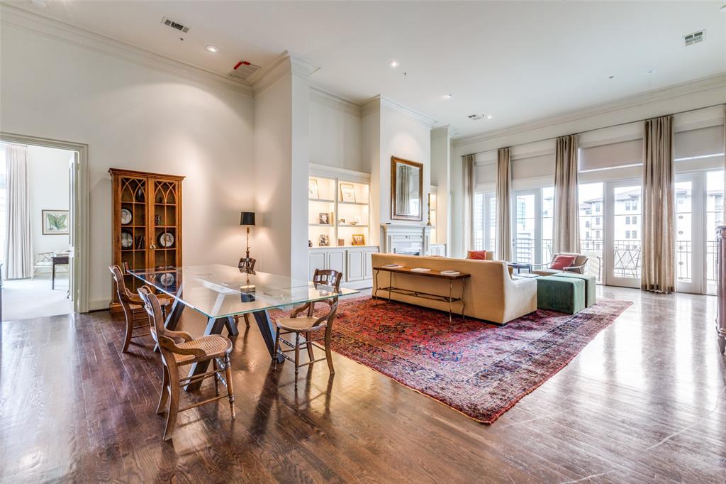 a living room with fireplace furniture and a rug