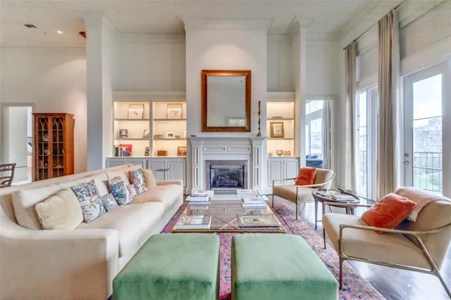 a living room with furniture fireplace and a large window