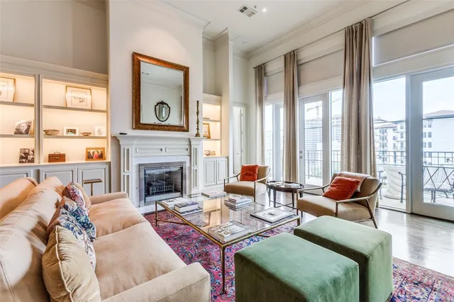 a living room with furniture fireplace and a large window