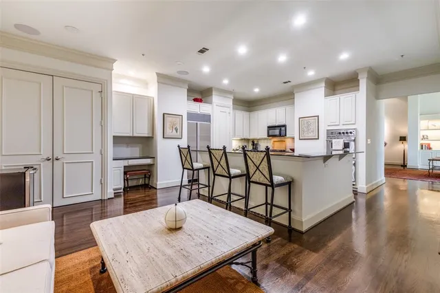 a open kitchen with white cabinets and stainless steel appliances