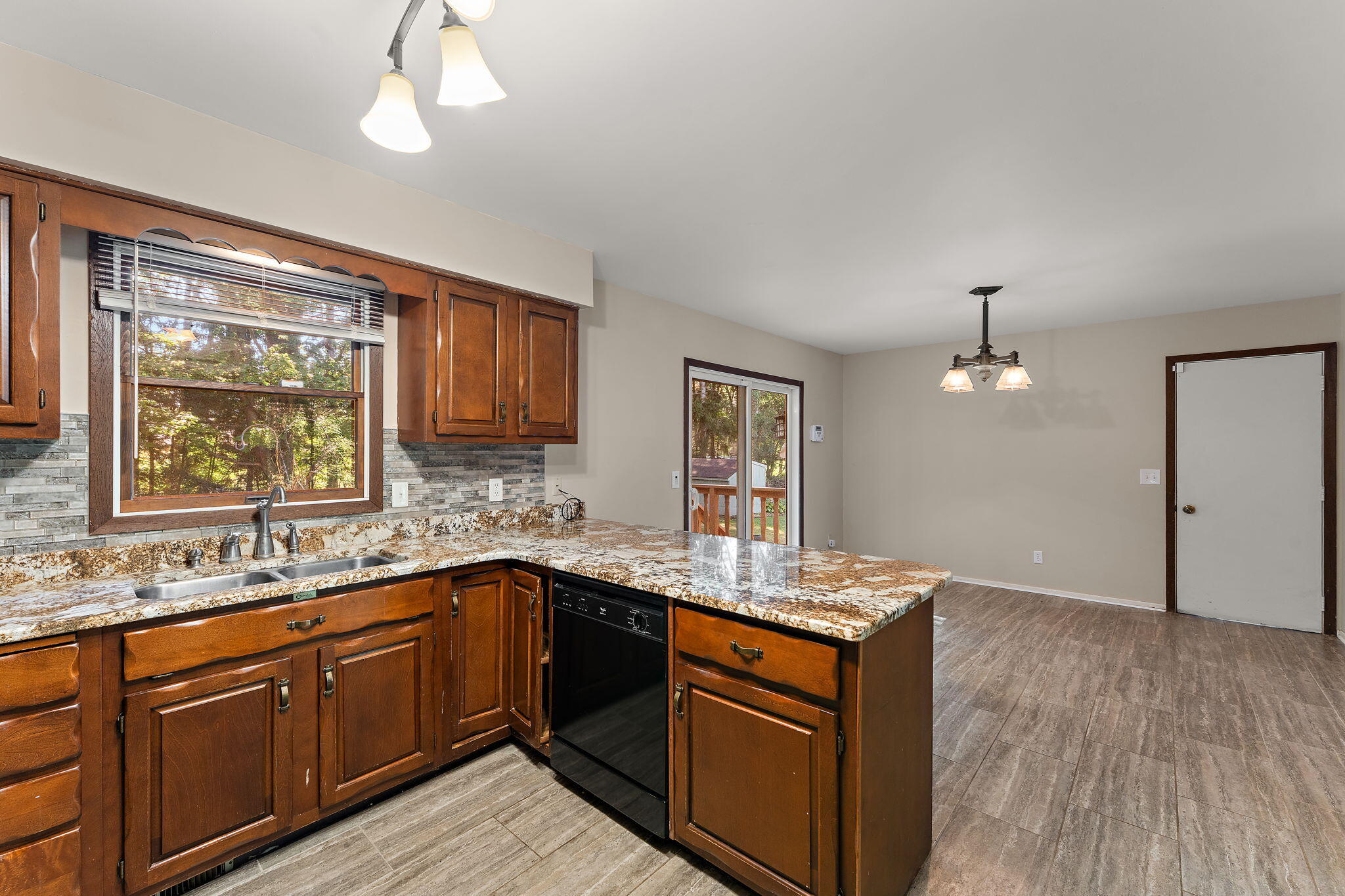 586 Fargo Road Westville, IN 46391 - Photo 11 of 40 a kitchen with stainless steel appliances granite countertop a sink and dishwasher with wooden floor