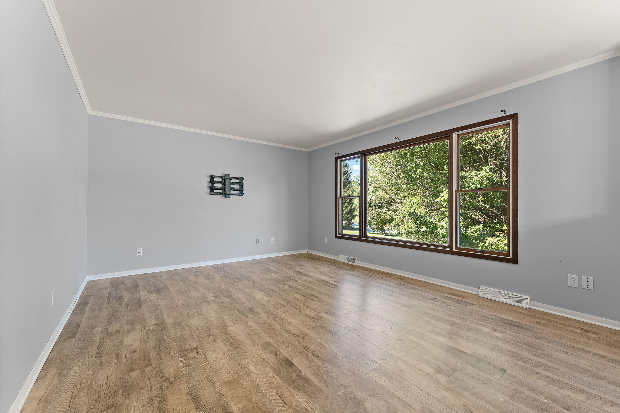 586 Fargo Road Westville, IN 46391 - Photo 5 of 40 a view of an empty room with wooden floor and a window