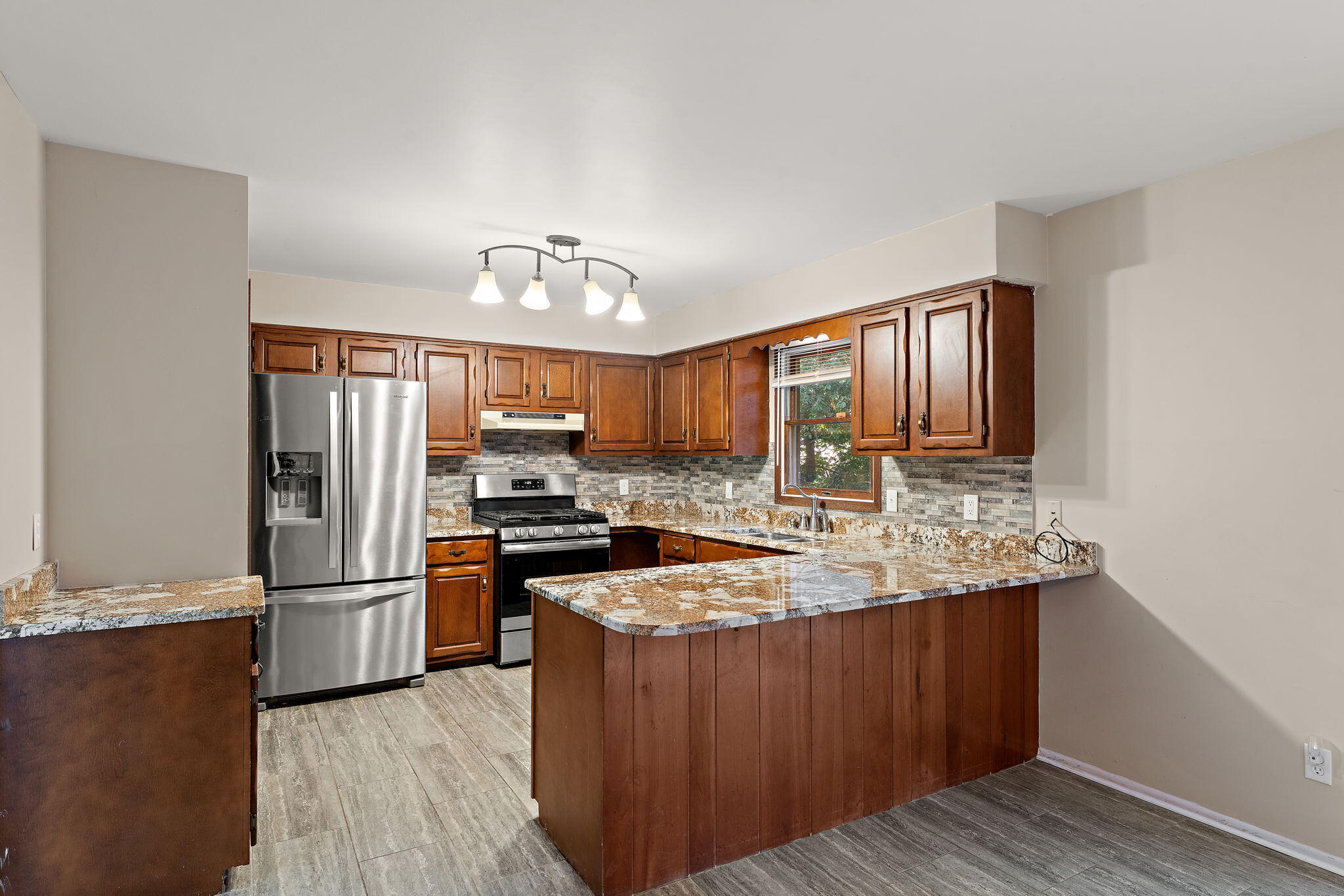 586 Fargo Road Westville, IN 46391 - Photo 8 of 40 a kitchen with stainless steel appliances granite countertop a refrigerator a stove and a sink