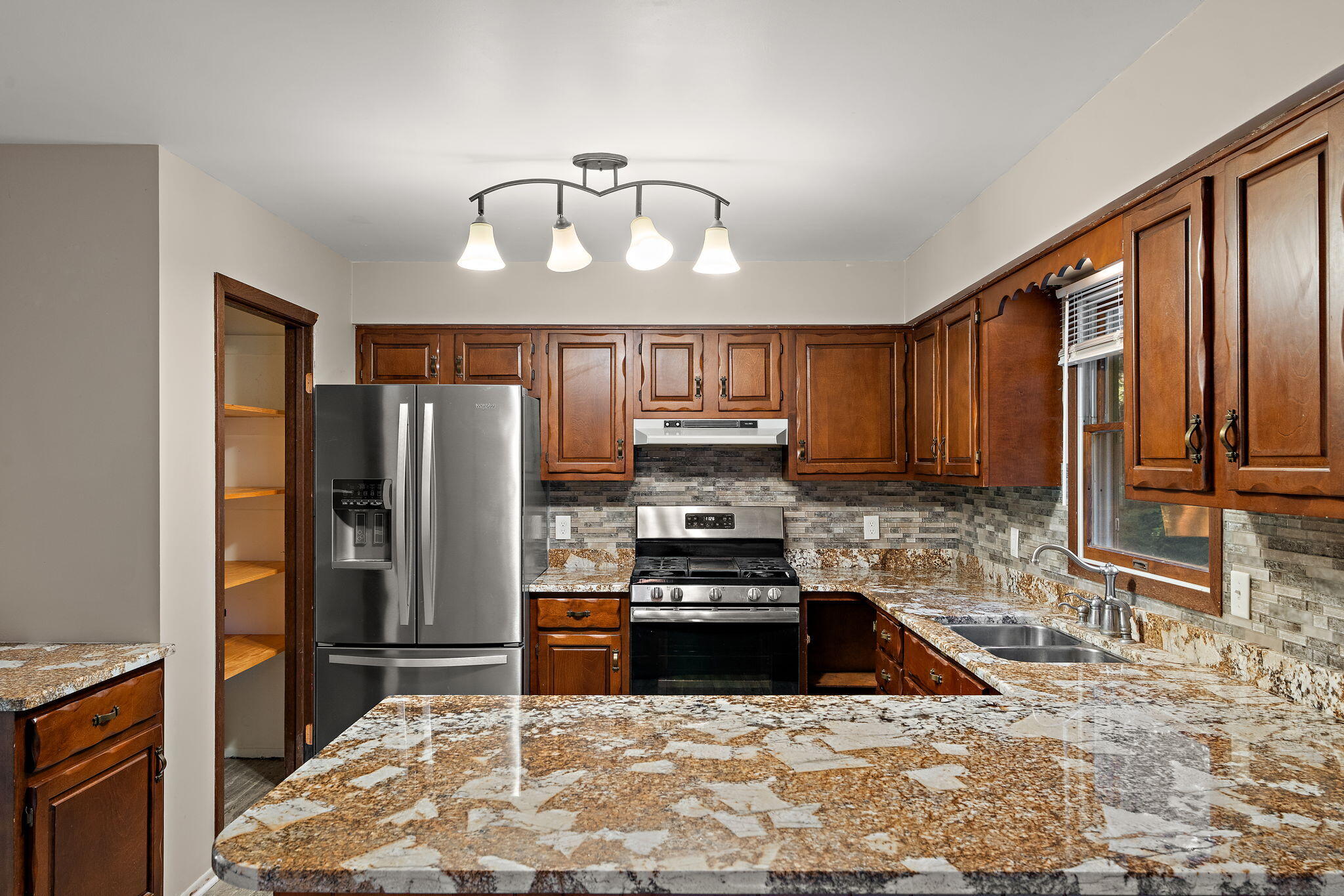 586 Fargo Road Westville, IN 46391 - Photo 9 of 40 a kitchen with stainless steel appliances a stove a refrigerator and a sink