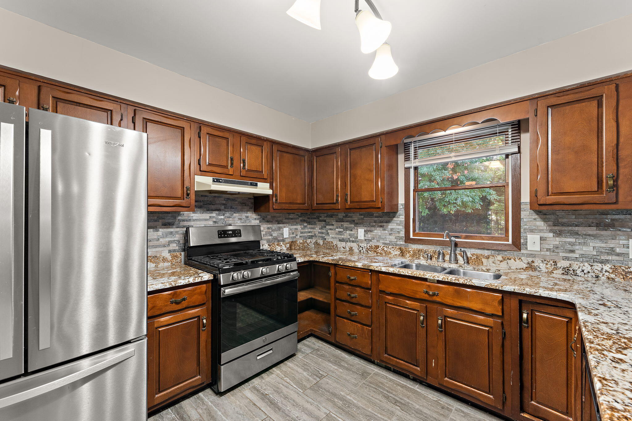 586 Fargo Road Westville, IN 46391 - Photo 10 of 40 a kitchen with stainless steel appliances granite countertop a refrigerator a sink dishwasher a stove top oven a refrigerator with island and cabinets