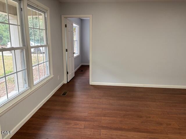 1208 Hatch Road Chapel Hill, NC 27516 - Photo 11 of 33 a view of an empty room with wooden floor and a window