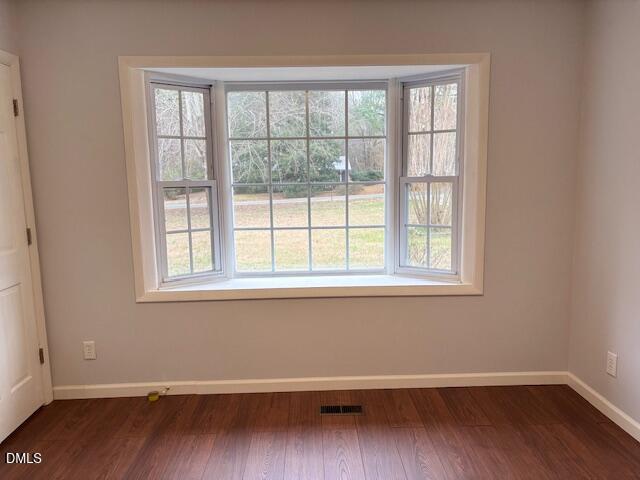 1208 Hatch Road Chapel Hill, NC 27516 - Photo 13 of 33 an empty room with wooden floor and windows