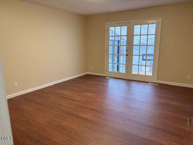 1208 Hatch Road Chapel Hill, NC 27516 - Photo 15 of 33 a view of an empty room with wooden floor and fan