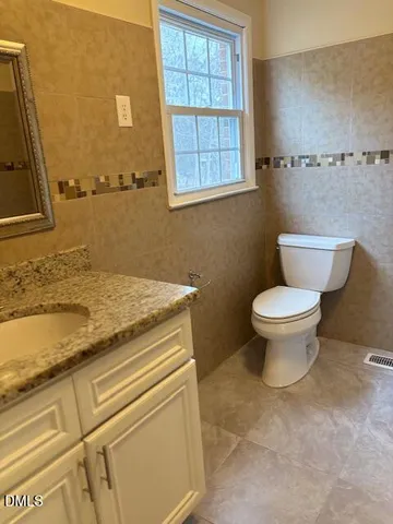 a white bath tub sitting next to a white wall
