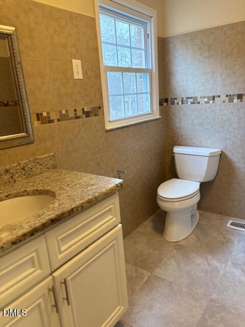 1208 Hatch Road Chapel Hill, NC 27516 - Photo 17 of 33 a bathroom with a granite countertop toilet and a sink