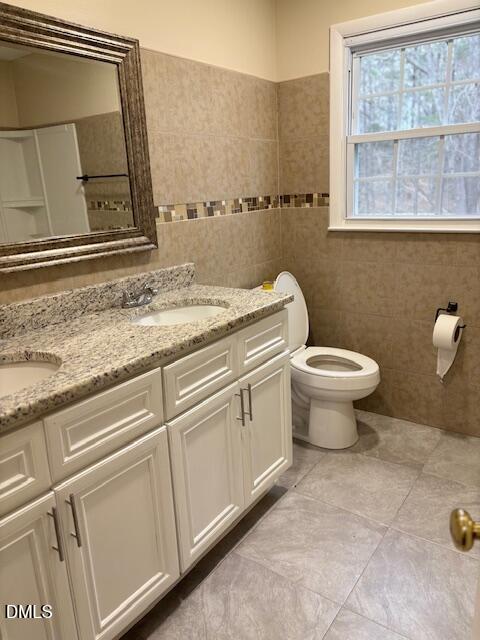 1208 Hatch Road Chapel Hill, NC 27516 - Photo 19 of 33 a bathroom with a granite countertop toilet and a sink
