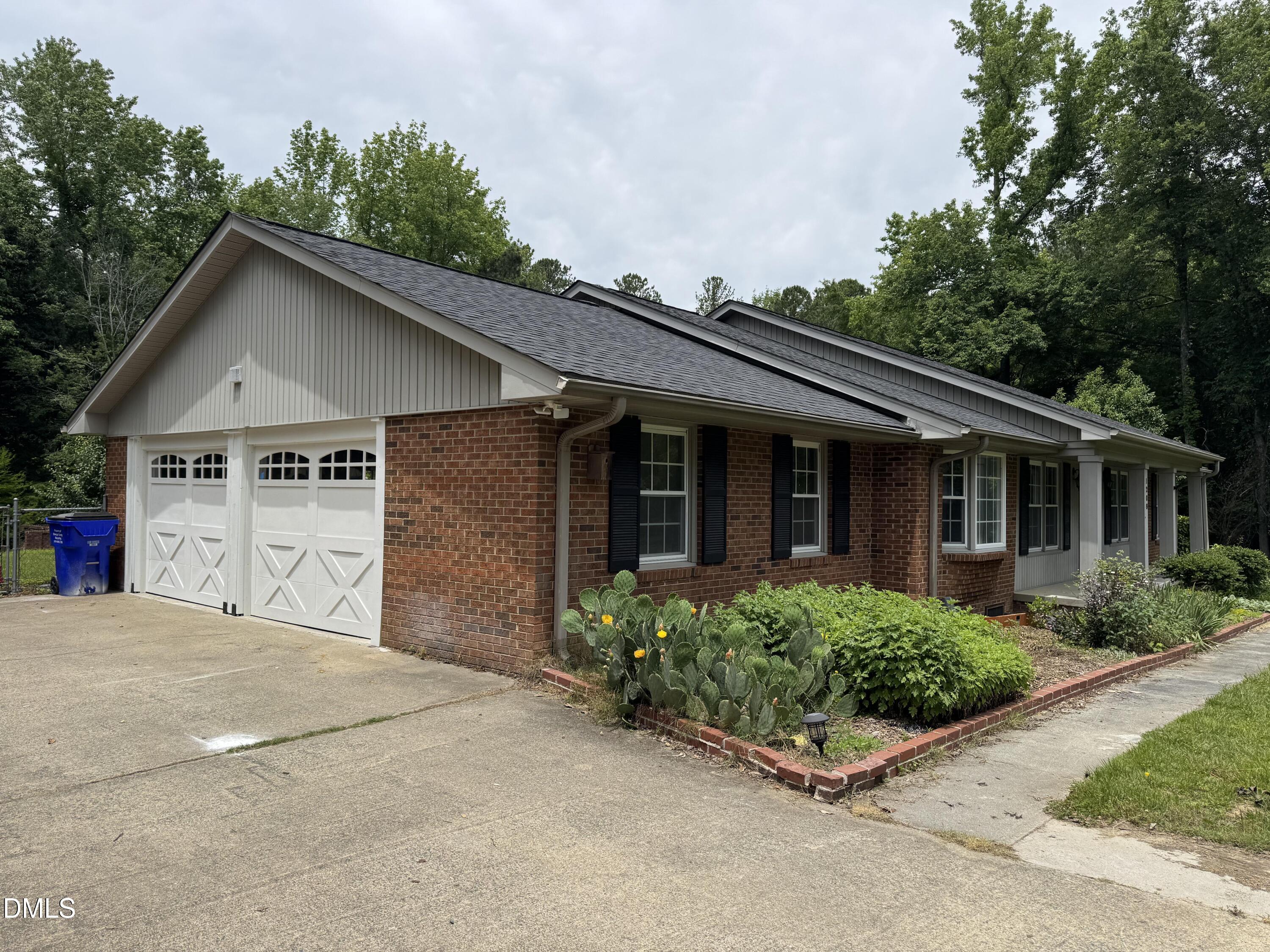 1208 Hatch Road Chapel Hill, NC 27516 - Photo 28 of 33 a view of a house with garage and plants