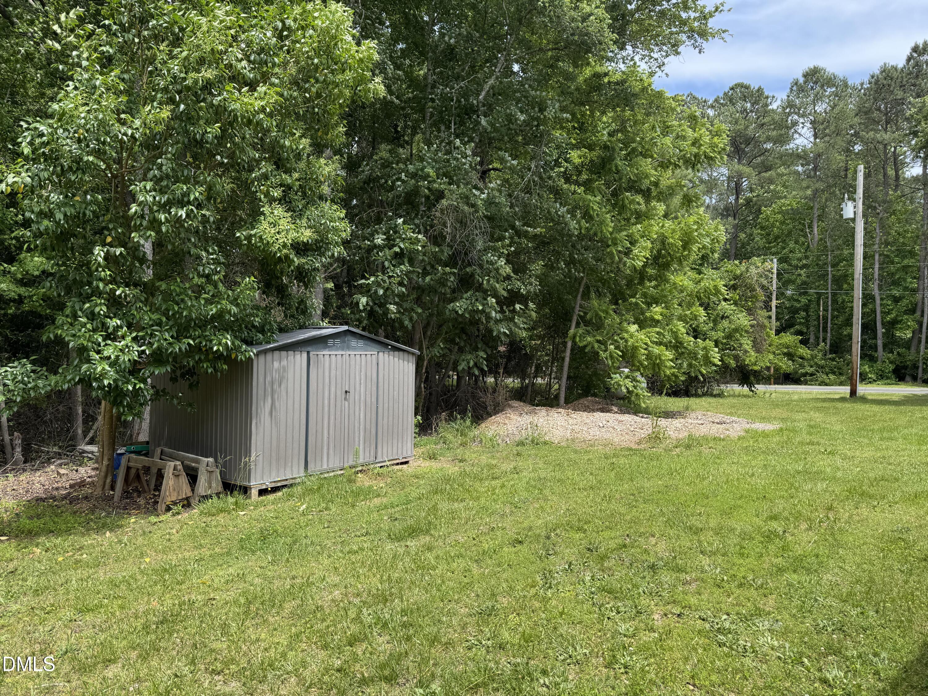 1208 Hatch Road Chapel Hill, NC 27516 - Photo 31 of 33 a backyard of a house with plants and large trees