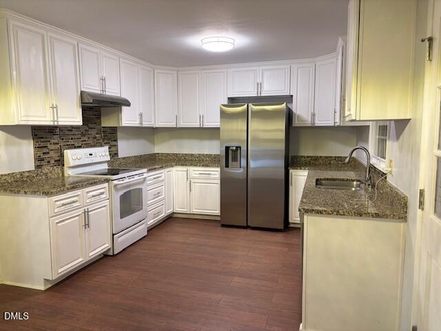 1208 Hatch Road Chapel Hill, NC 27516 - Photo 6 of 33 a kitchen with stainless steel appliances granite countertop white cabinets a sink a stove a refrigerator with grey cabinets