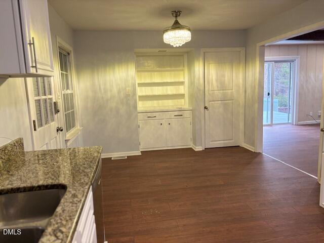 1208 Hatch Road Chapel Hill, NC 27516 - Photo 7 of 33 a view of a livingroom with wooden floor and kitchen space