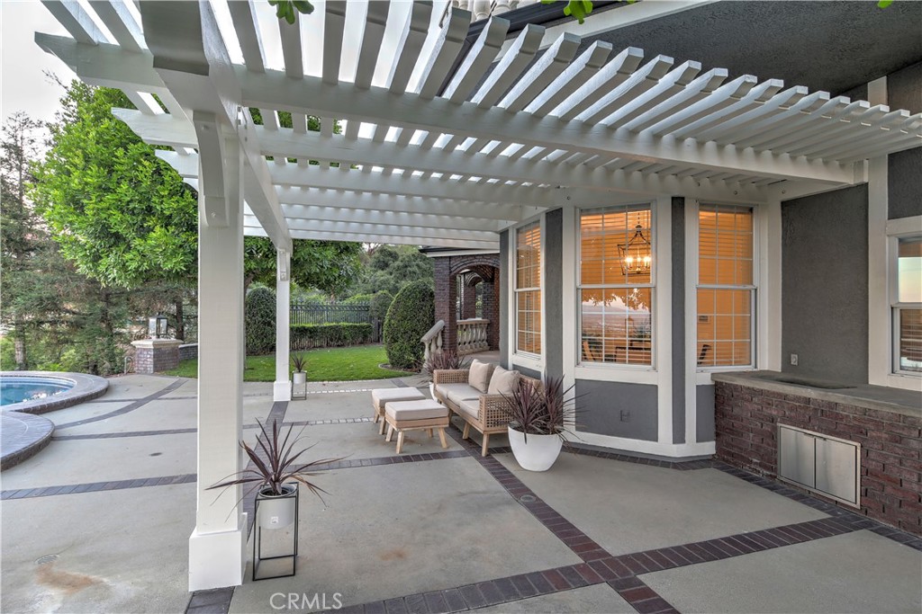 1016 Briarcliff Road Monrovia, CA 91016 - Photo 57 of 70 a view of a patio with table and chairs and floor to ceiling window with wooden fence