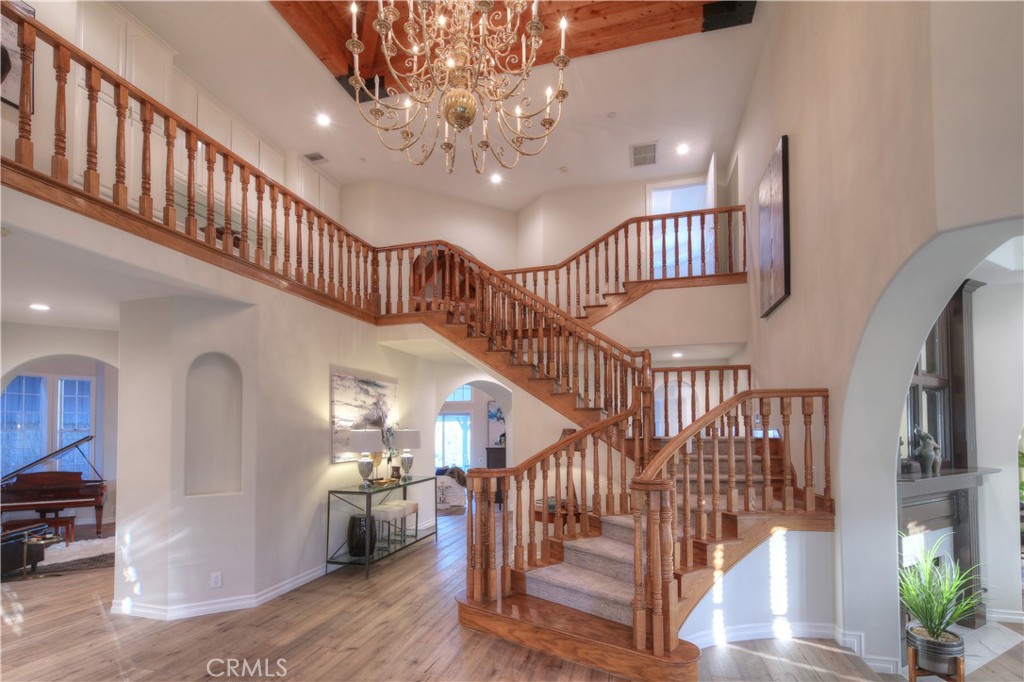 1016 Briarcliff Road Monrovia, CA 91016 - Photo 9 of 70 a view of staircase with lots of frames and a chandelier
