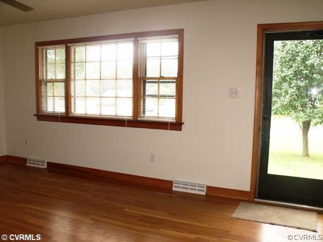 9932 Reams Road North Chesterfield, VA 23236 - Photo 7 of 22 an empty room with wooden floor and windows