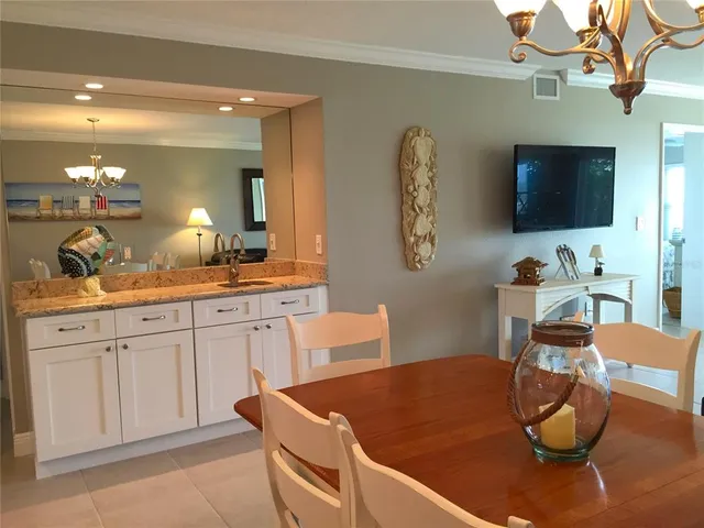 a living room with furniture a window and a flat screen tv