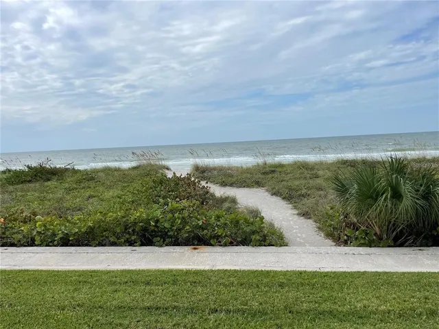 a kitchen with stainless steel appliances kitchen island granite countertop a refrigerator and a stove