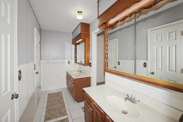 a bathroom with a tub sink and mirror