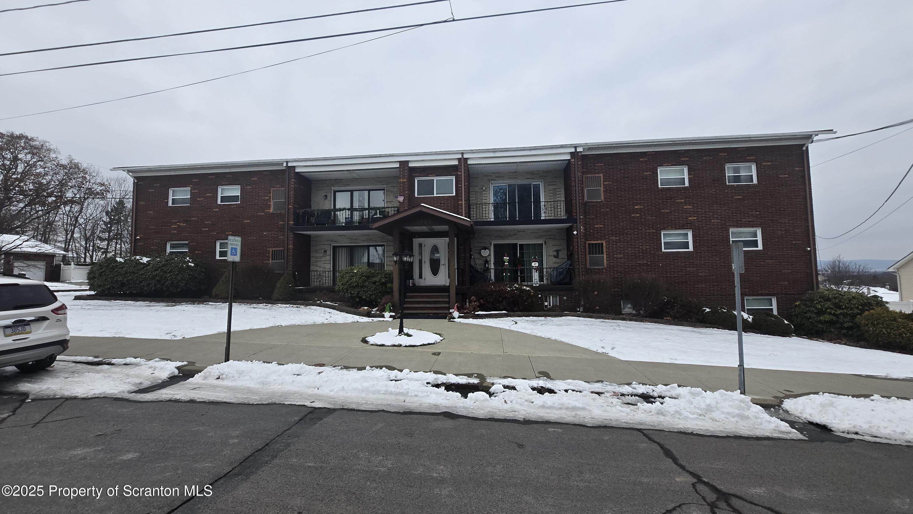3730 Lawrence Avenue, Unit 7 Moosic, PA 18507 - Photo 1 of 10 a street sign on a pole on a street