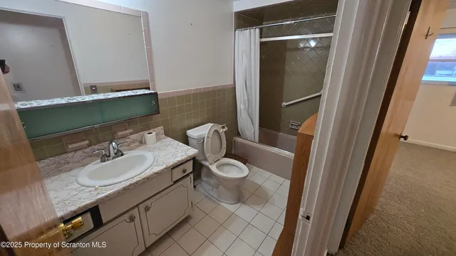 a bathroom with a granite countertop sink toilet and a mirror