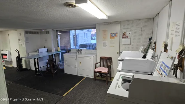 a room with furniture a rug kitchen view and a window