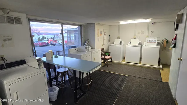 a view of a dining room with furniture large window and glass door