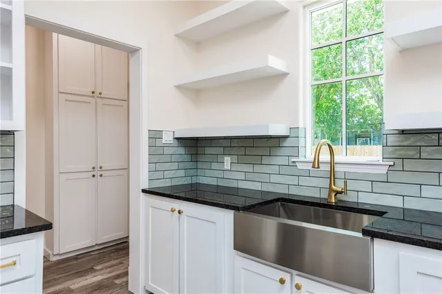 a kitchen with granite countertop a sink and a window
