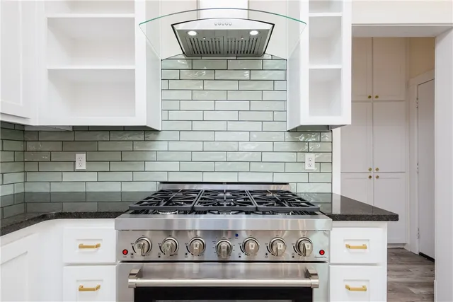 a stove top oven sitting inside of a kitchen
