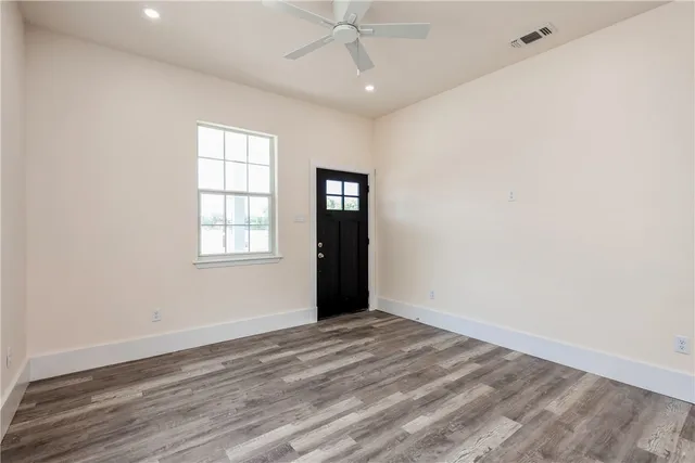 wooden floor in an empty room with a window