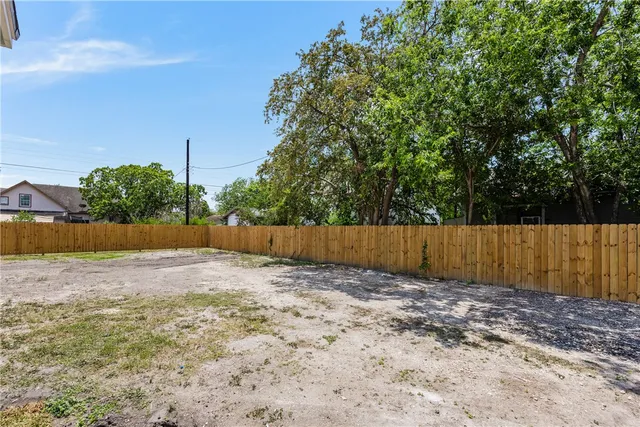 a view of a backyard with fence