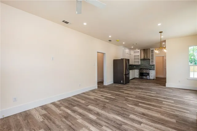 a view of a kitchen with a refrigerator and a window