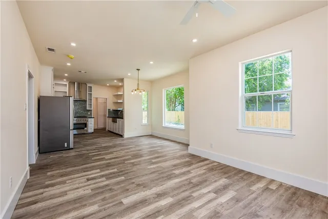 a view of a kitchen with a refrigerator and a window