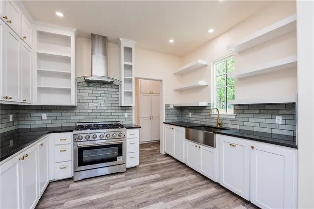 a large kitchen with a stove and a sink