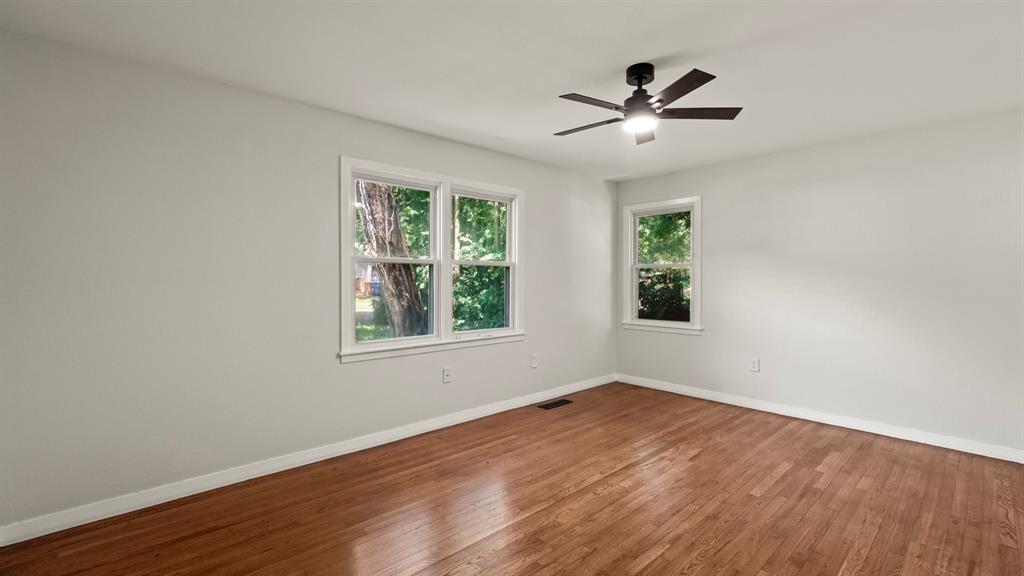 4600 Robinwood Drive Waco, TX 76708 - Photo 15 of 24 a view of empty room with wooden floor and fan