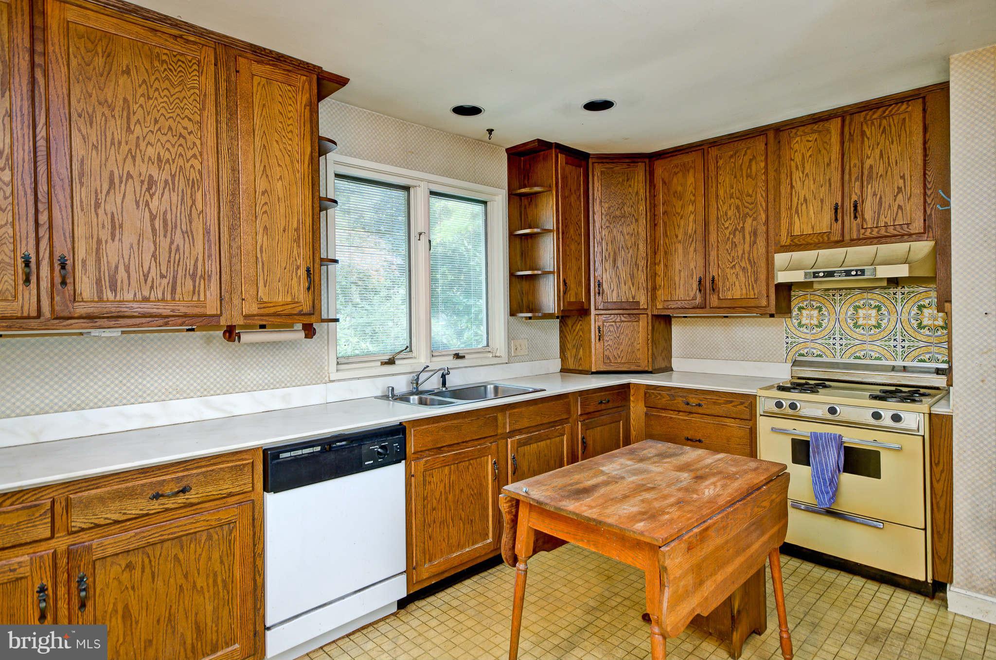 7308 Stafford Road Alexandria, VA 22307 - Photo 18 of 30 a kitchen with stainless steel appliances granite countertop wooden cabinets a sink and a stove